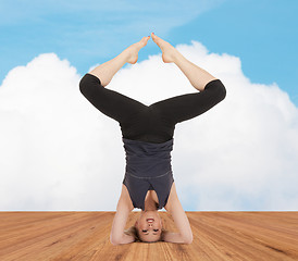 Image showing happy young woman doing yoga exercise