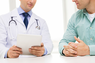 Image showing close up of male doctor and patient with tablet pc