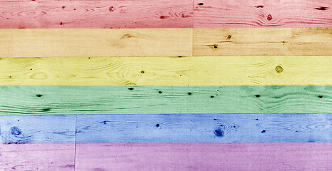 Image showing gay pride rainbow flag pattern on wooden surface