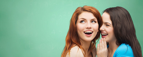 Image showing happy student girls whispering secret or gossip