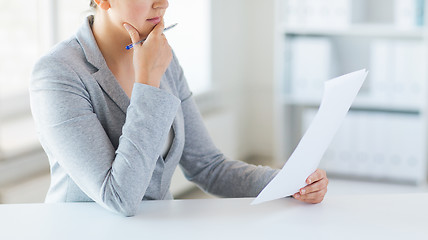 Image showing close up of woman reading papers or tax report