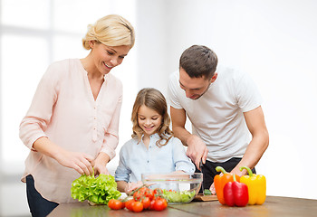 Image showing happy family cooking vegetable salad for dinner