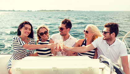 Image showing smiling friends with glasses of champagne on yacht