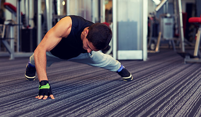 Image showing man one arm push-ups in gym