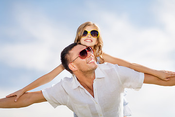 Image showing happy father and child in sunglasses over blue sky