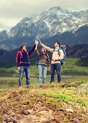 Image showing group of smiling friends with backpacks hiking