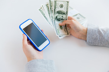 Image showing close up of woman hands with smartphone and money