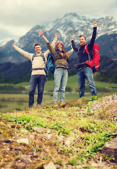 Image showing group of smiling friends with backpacks hiking