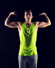 Image showing young man showing biceps