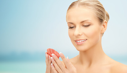 Image showing beautiful woman with seashell over blue background