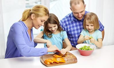 Image showing happy family with two kids cooking at home