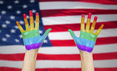 Image showing hands painted in rainbow colours and american flag