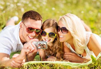 Image showing happy family with camera taking picture