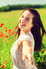 Image showing laughing young woman on poppy field