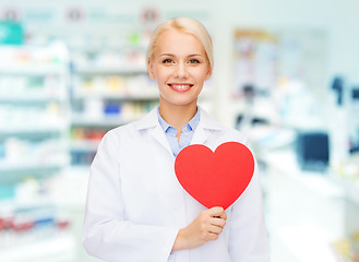 Image showing woman pharmacist with heart at drugstore