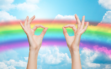 Image showing hands showing ok sign over rainbow background