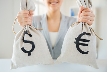 Image showing close up of woman hands holding money bags