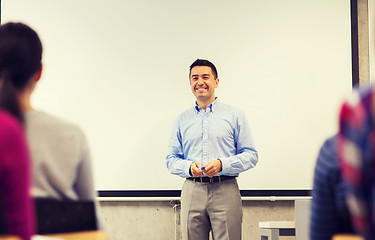 Image showing group of students and smiling teacher in classroom