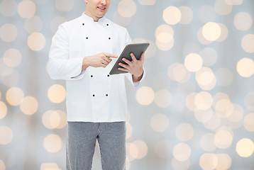 Image showing close up of happy male chef cook holding tablet pc