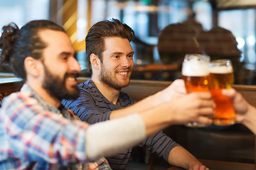 Image showing happy male friends drinking beer at bar or pub