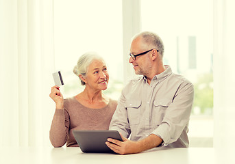 Image showing happy senior couple with tablet pc and credit card
