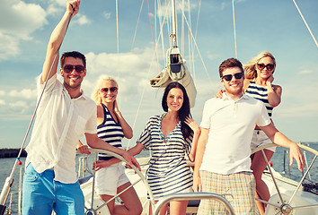 Image showing smiling friends sailing on yacht