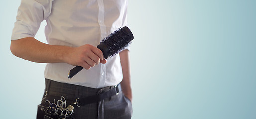 Image showing close up of male stylist with brush at salon