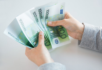 Image showing close up of woman hands counting euro money