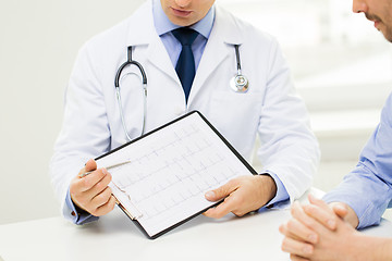 Image showing close up of male doctor and patient with clipboard