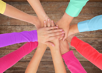 Image showing close up of women hands on top in rainbow clothes