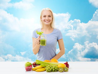 Image showing smiling woman drinking juice or shake over sky