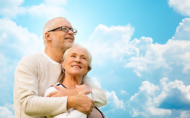 Image showing happy senior couple over blue sky and clouds