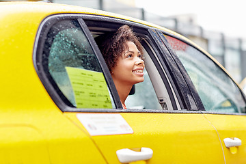 Image showing happy african american woman driving in taxi