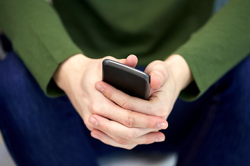 Image showing close up of male hands with smartphone