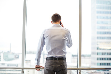 Image showing businessman calling on smartphone in office