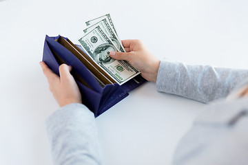 Image showing close up of woman hands with wallet and money