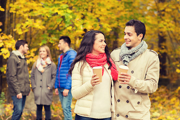 Image showing group of smiling friend with coffee cups in park