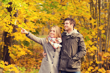 Image showing smiling couple hugging in autumn park