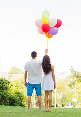 Image showing happy couple with air balloons in city