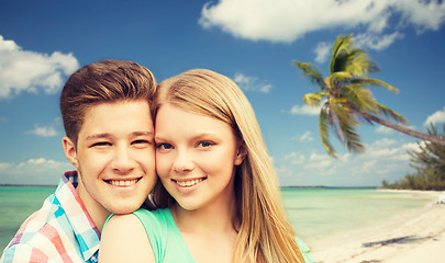 Image showing smiling couple hugging over beach background