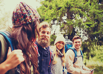 Image showing group of friends with backpacks and tablet pc