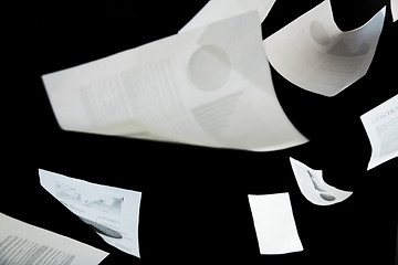 Image showing business papers falling down over black background