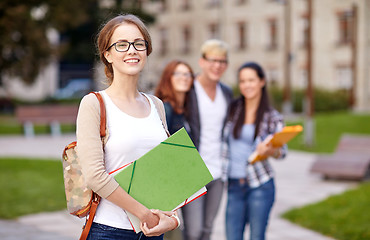 Image showing happy teenage students with school folders