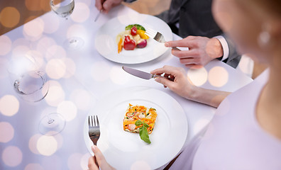 Image showing close up of couple eating appetizers at restaurant