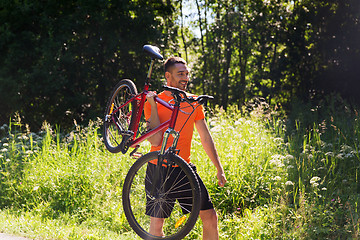 Image showing happy young man riding bicycle outdoors