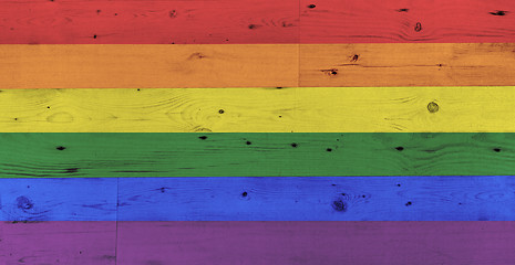 Image showing gay pride rainbow flag pattern on wooden surface