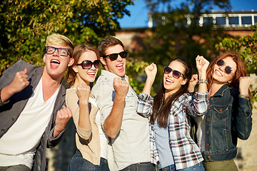 Image showing group of happy friends showing triumph gesture