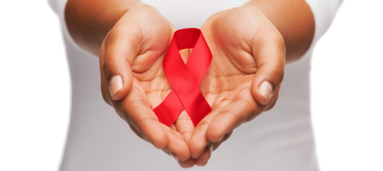 Image showing hands holding red AIDS awareness ribbon