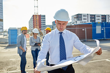 Image showing architect with blueprint on construction site