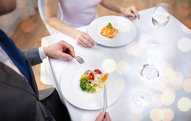 Image showing close up of couple eating appetizers at restaurant